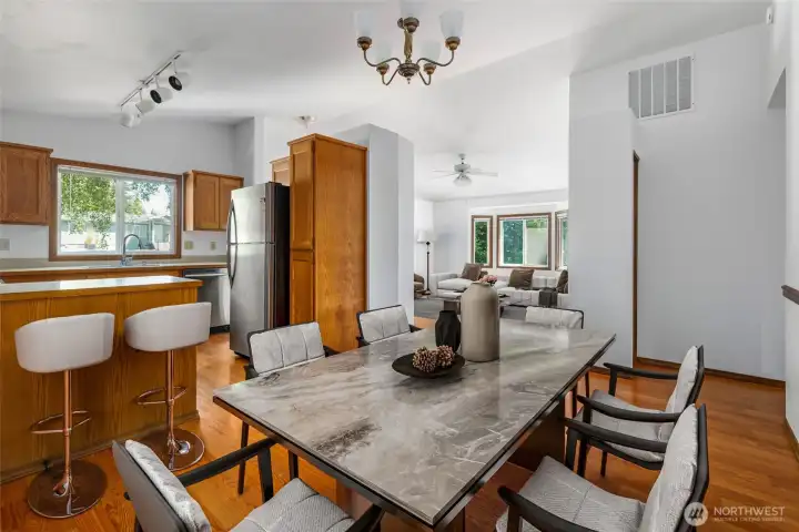 Dining Room virtually staged with room to sit at breakfast bar at kitchen - a great place to gather