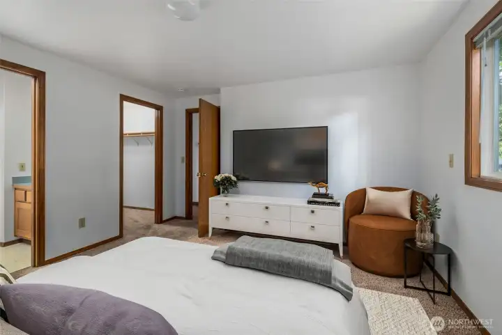 Primary Bedroom virtually staged  is a  nice size and view of walk in closet and full bath
