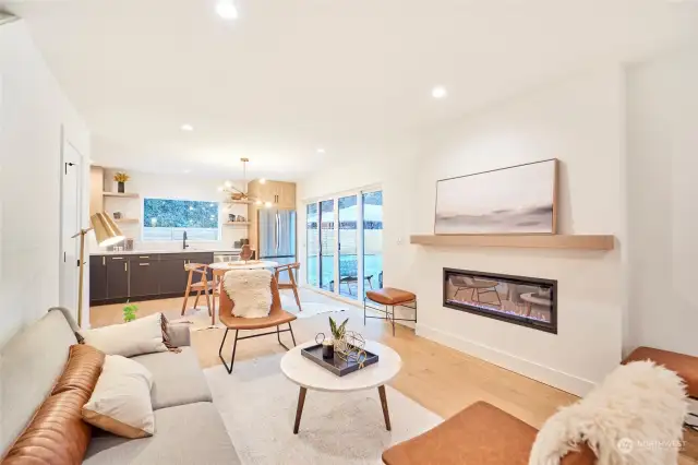 Open floor plan with warm fireplace as focal point featuring white oak mantel.