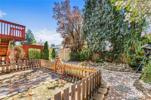 Adorable back yard with fenced garden area.