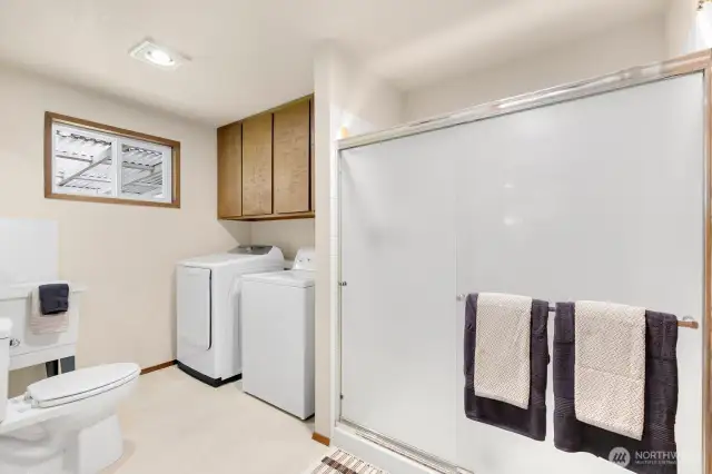 Large laundry room with storage and 3/4 bath sits off entrance to garage, making clean-up easy!