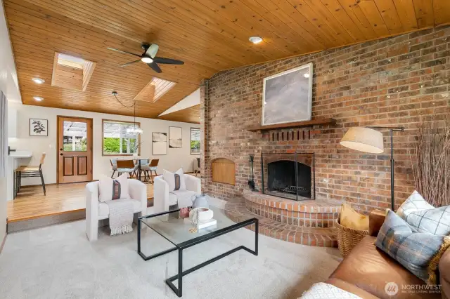 Main living room with showpiece, wood-burning fireplace.