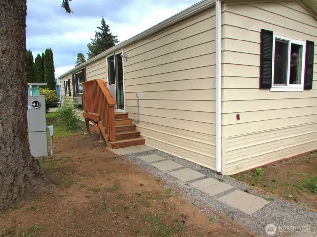 PAVER WALKWAY LEADS TO BACK DECK.