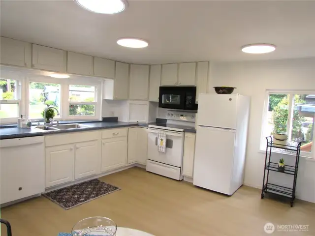 UPDATED KITCHEN CABINETS AND NEW FLOORING THRU-OUT.