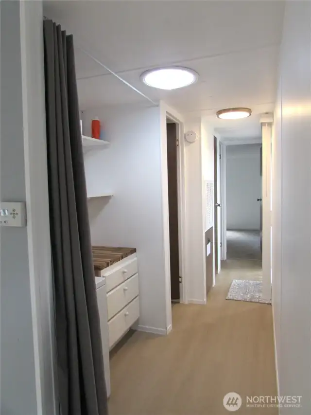 NEW PAINT, TRIM AND LIGHTING, HALLWAY TO BEDROOMS & BATH.