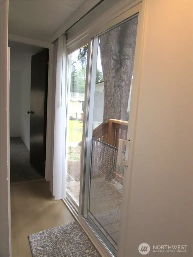 END OF HALL, OUTDOOR ACCESS ON RIGHT.