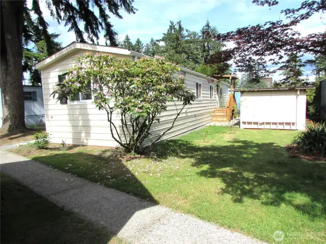 NICE YARD AREA BEHIND CARPORT W/ STORAGE.