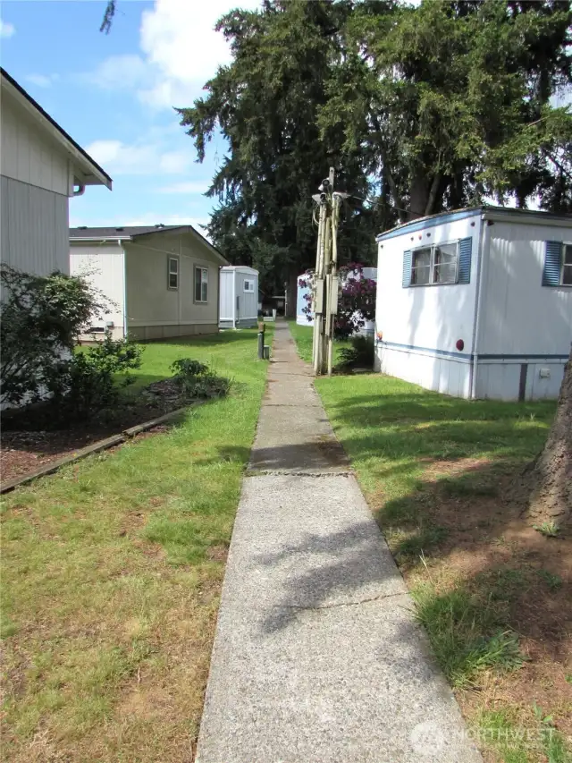 COMMUNITY SIDWALK BEHIND HOME LEADS TO PARK OFFICE.
