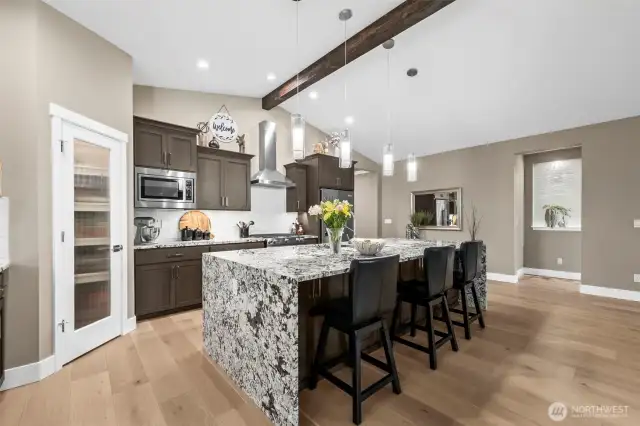 Top quality cabinets, stainless appliances and pendant lighting in this hub-of-the-home kitchen