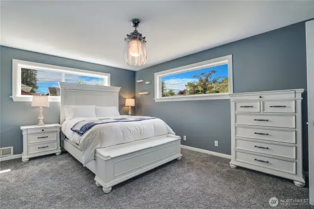 With sun-filled windows and updated carpet (2023), this serene primary suite offers the perfect escape. Whether unwinding after a long day or starting the morning with natural light streaming in, this primary bedroom is designed for relaxation and comfort.