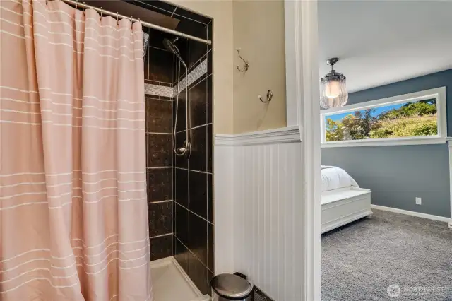 Step into relaxation with a spacious walk-in shower featuring a full tile surround, offering both style and durability.