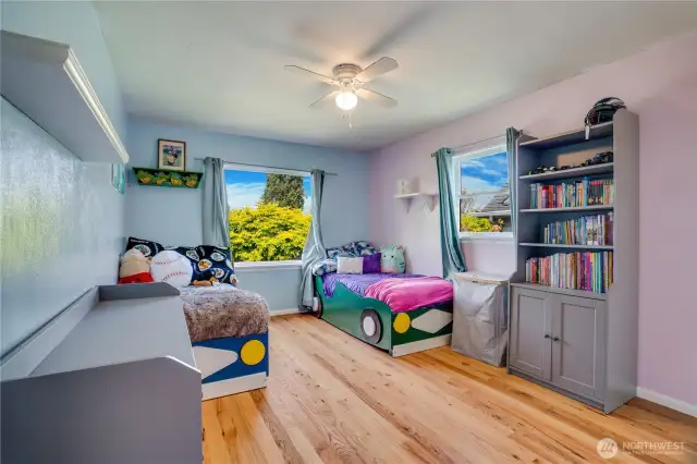 Spacious and welcoming, this second additional bedroom boasts refreshed hardwood floors and two sun-filled windows.