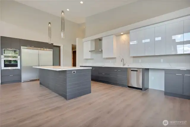 Quartz 2cm Kitchen Counter • Full Height Custom Backsplash • Inspired Pendant Lighting Over Kitchen Island • Walk-In Pantries