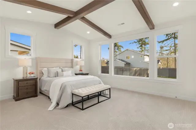 Beamed Ceiling are vaulted in the Primary Suite creating a spacious feel to the room.