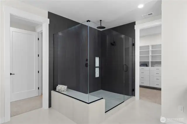 Love this Large walk-in Shower in the Primary Suite appointed with Dramatic Tile Floors and accent walls!