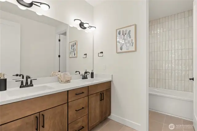 Quartz Counters and deco Tiles create a beautiful secondary bath.
