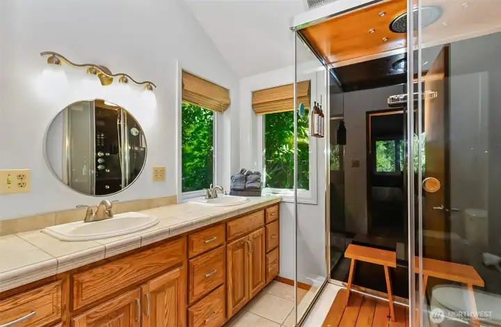 The luxurious primary suite bathroom features a double sink vanity and gorgeous walk-in shower.