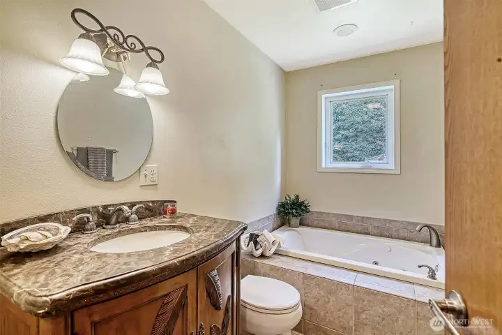 Full bath on the main level features a jetted tub.