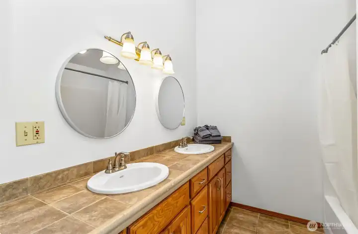 The primary suite on the upper level includes this full bath with double sink vanity.