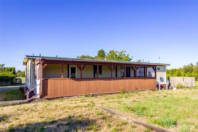 Back of home has a large covered back deck.