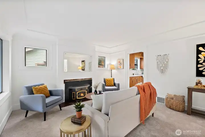 Living room offers a cozy fireplace nook.