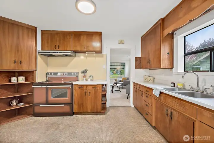 Kitchen features warm cabinets and counter space.