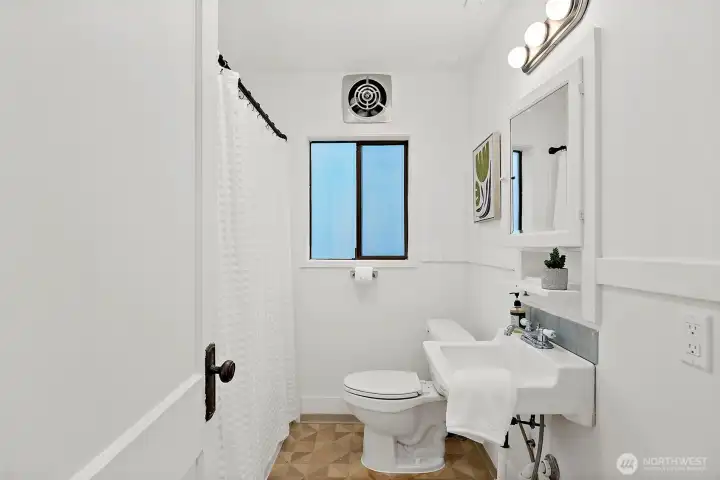 Bathroom includes a modern shower setup.