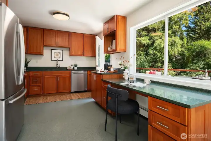 Flex your culinary skills in the roomy kitchen with a lovely outlook of the expansive back yard.