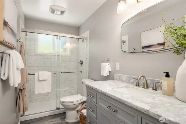Refreshed main bathroom with crisp subway tile and marble counter top.