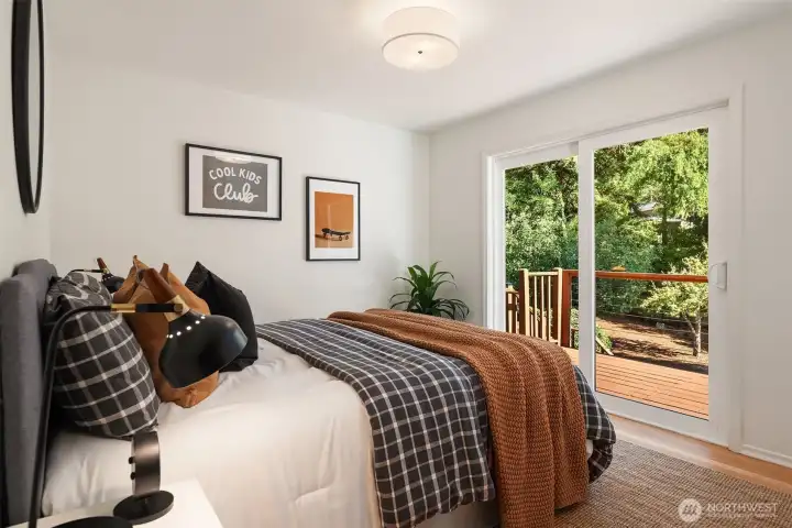 Northeast bedroom on main floor with slider to deck overlooking gardens.