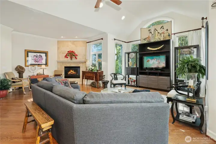 Spacious great room off the kitchen, with distinct areas for TV, conversation, and quiet reflection.