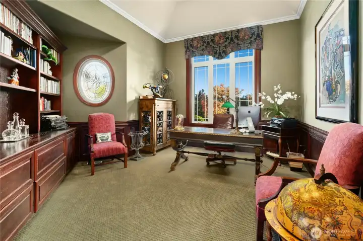 A distinguished office with ample built-in storage and room to work or read in comfort.