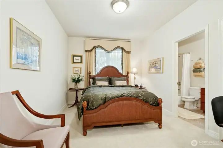 Two main-floor bedrooms provide easy, step-free access—ideal for extended family. Each includes a full bath for comfort and convenience. This bedroom #2 was affectionately dubbed ‘Mom’s Room.’