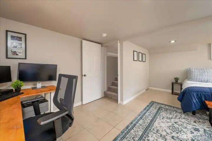 The downstairs bonus room is currently used as a guest room and home office.  Storage availabe under the stairs.