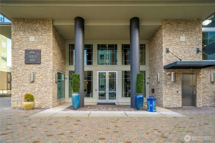 The elegant entrance of the Baker Building at Point Ruston showcases modern design and secure building access. Residents appreciate the well-maintained exterior, stylish architectural details, and the convenience of being moments from Ruston Way’s waterfront, parks, and local amenities.
