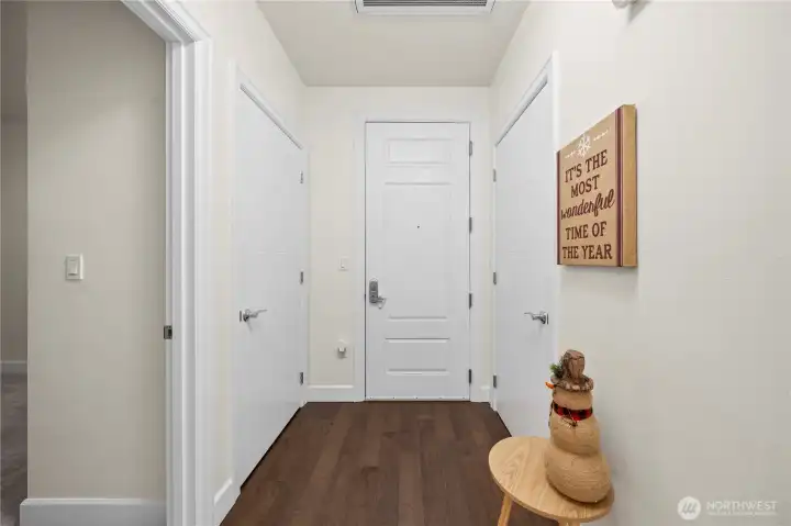 A welcoming foyer sets the tone for the home with warm flooring, clean lines, and multiple doors leading to storage and utility spaces. This functional entry layout keeps essentials accessible while offering a calm transition into the main living area.