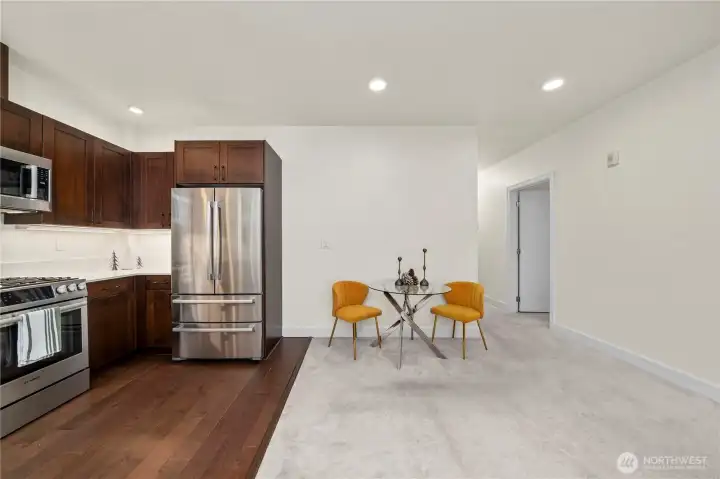 This view showcases the smooth transition from the kitchen to the dining nook, offering flexible space for meals or work-from-home needs. The open layout enhances flow throughout the unit while maintaining a cozy, comfortable feel.