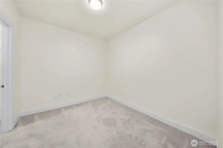 This bright secondary bedroom offers a clean, versatile layout perfect for creating a quiet workspace, guest room, or hobby area. Soft carpeting and neutral colors enhance comfort while providing a blank canvas for your personal style.