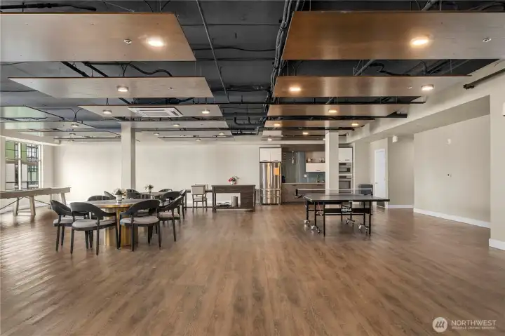 This expansive community room offers multiple seating areas, game tables, and an open layout perfect for hosting gatherings or social events. Modern finishes and warm wood flooring create an inviting atmosphere for residents to enjoy year-round.