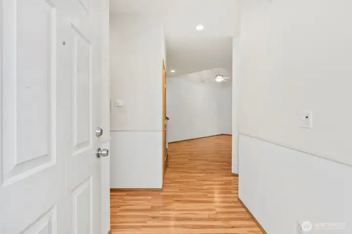Entryway with kitchen off to right, hallway to half bathroom, utility room and garage entry to the left. Straight ahead into living room with staircase to upstairs bedrooms right before entering living room.