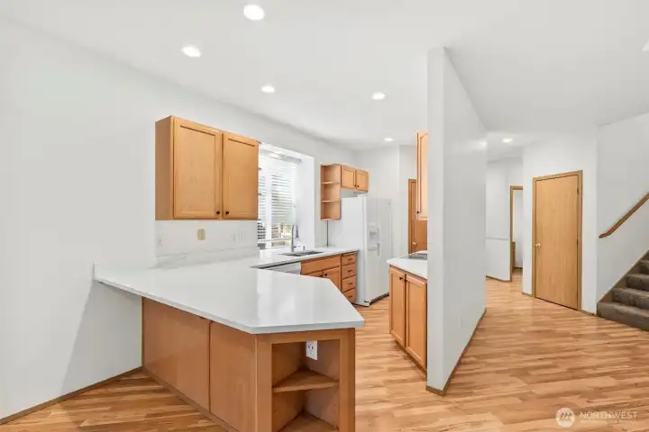 Open flow on main floor for effortless entertaining, with ample counterspace and storage. Laminate hardwood flooring throughout main floor.