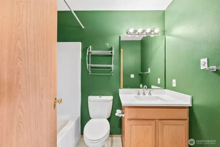 Full bathroom on upper level, vinyl flooring and updated vanity countertop, undermount sink and fixtures.