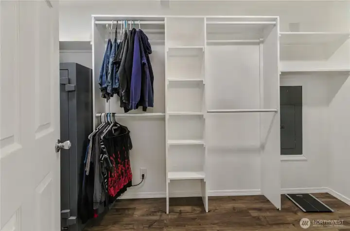 Convenient Built-ins make the large walk-in closet extra functional.