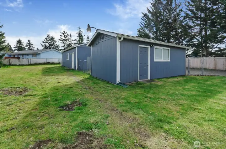 Additional shed provides space for hobby, storage or office.