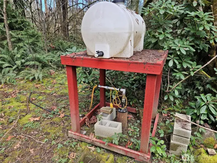 Well and water storage tank set up to be run from a portable generator