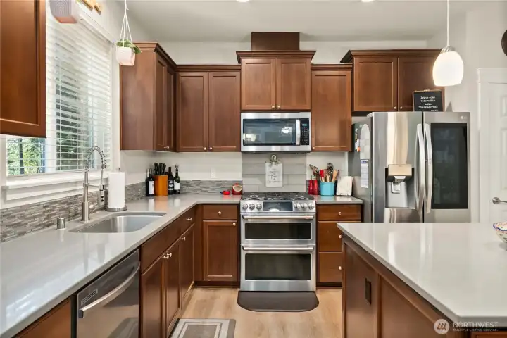 Double-oven Range/Stove located next to the refrigerator.