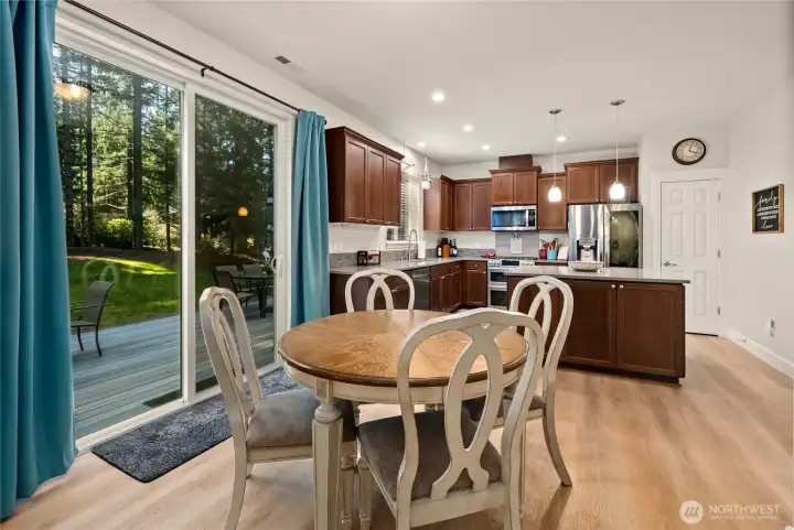 Breakfast nook space between kitchen and living room with access to slider leading you out to the backyard.