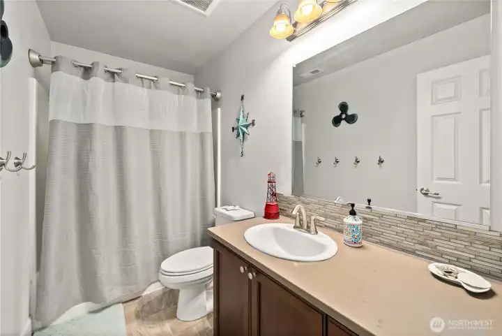 Full bath upstairs with one sink giving you extra counter space and large wall mirror.