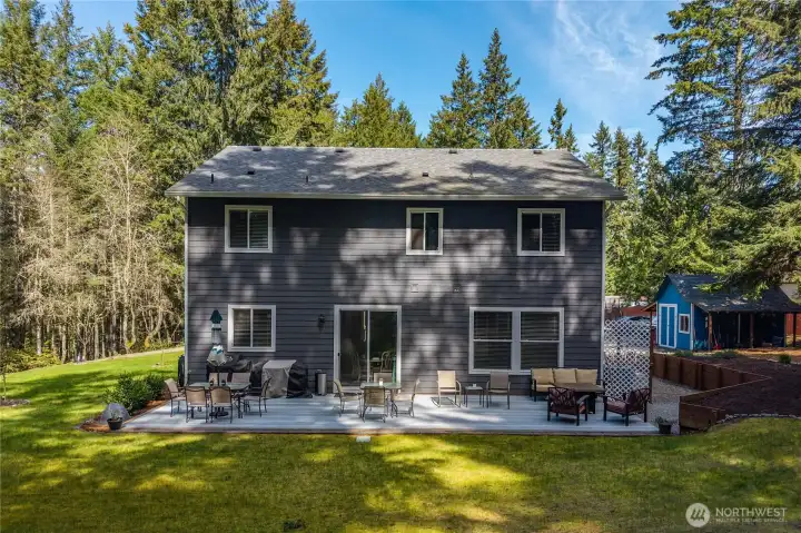 Large deck spans the width of the rear of the house. Plenty of space for outside dining, grilling tools, lounging set and more.