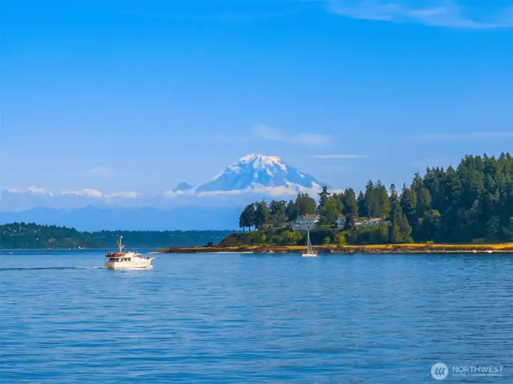 Mt. Rainier standing tall behind The Country Club of Seattle and Restoration Point.